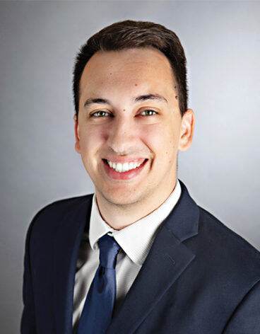 A person in a suit smiling