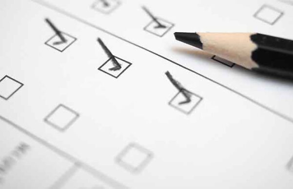 Photo of paper survey with checkmarks and pencil