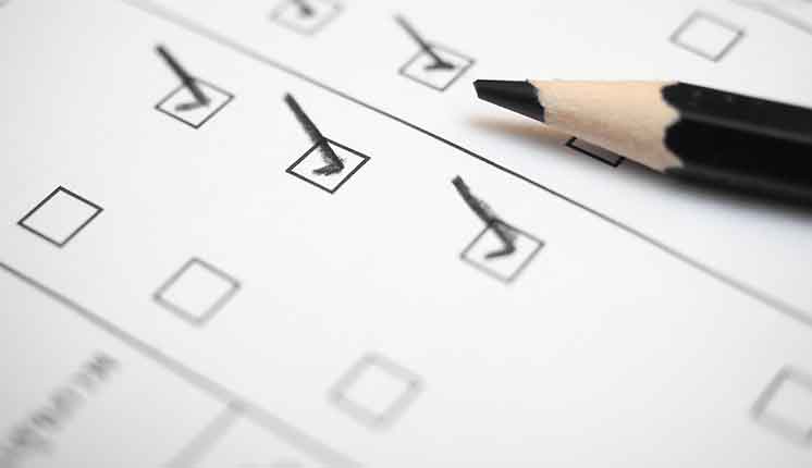 Photo of paper survey with checkmarks and pencil