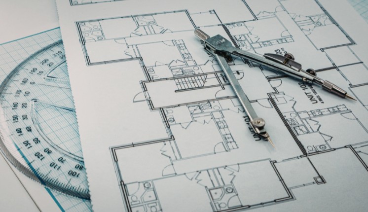 Construction drawings on a table with a protractor