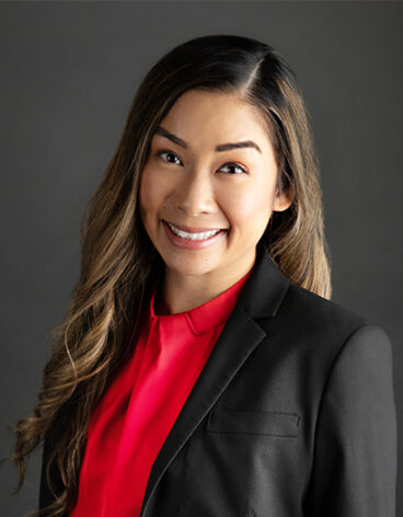 A person in a suit and red shirt
