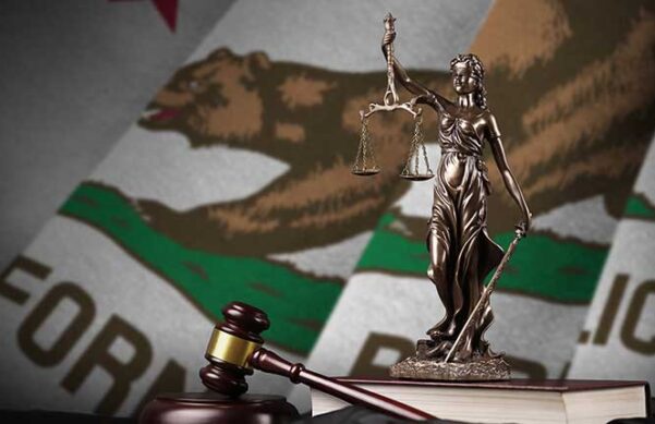 scales of justice and gavel with California State flag as background