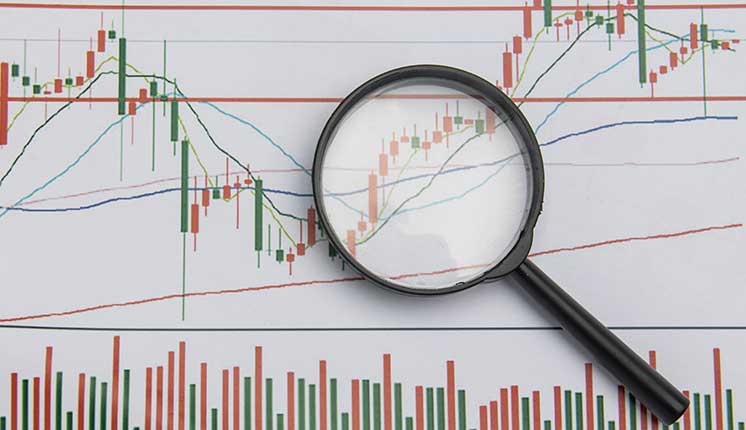 Graphs on large paper beneath a magnifying glass