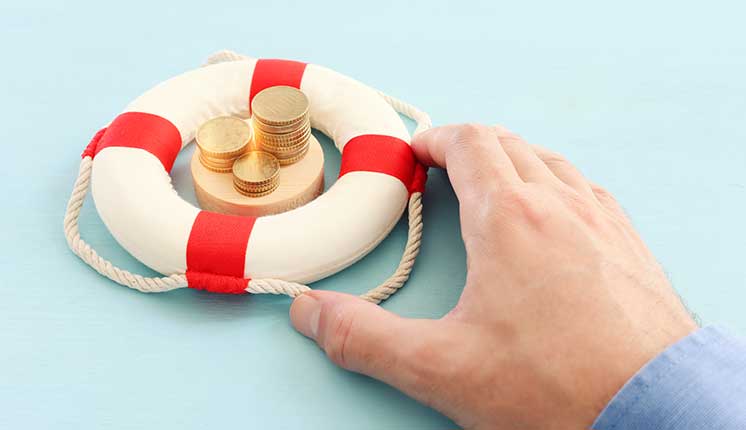 hand grasping a bouy on blue background with coins floating in the middle