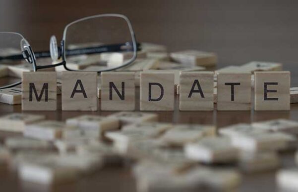 wooden blocks with lettering on a table top in front of a pair of glasses