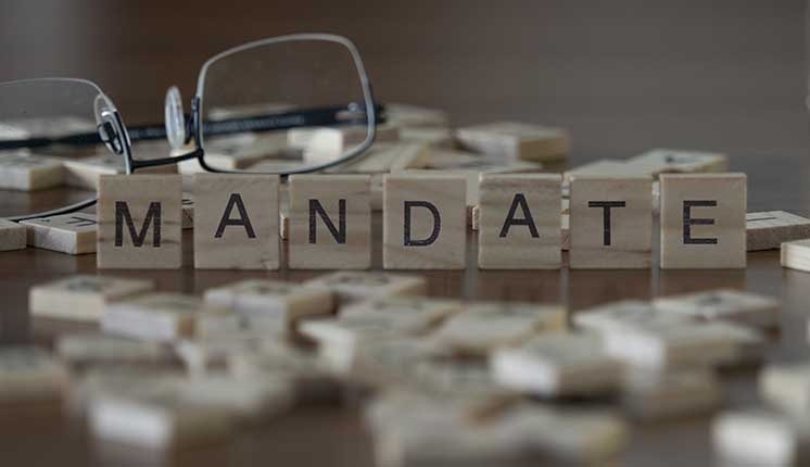 wooden blocks with lettering on a table top in front of a pair of glasses
