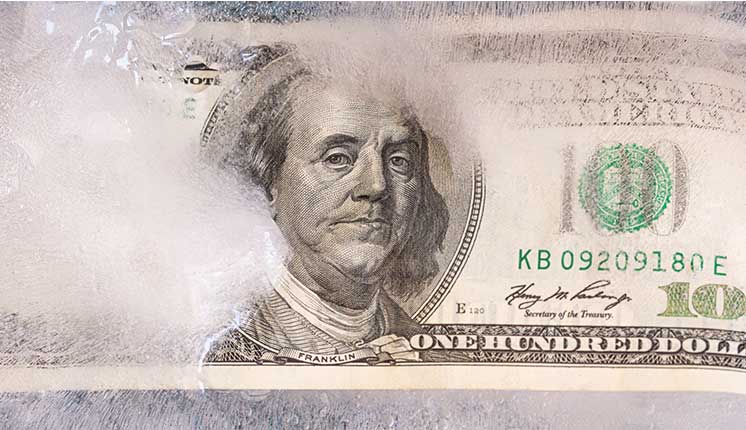 money frozen under layer of ice