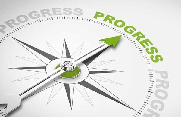 compass with the word progress