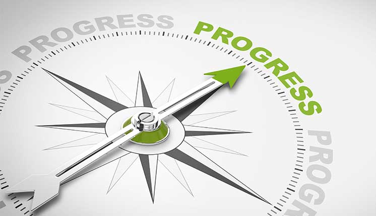 compass with the word progress