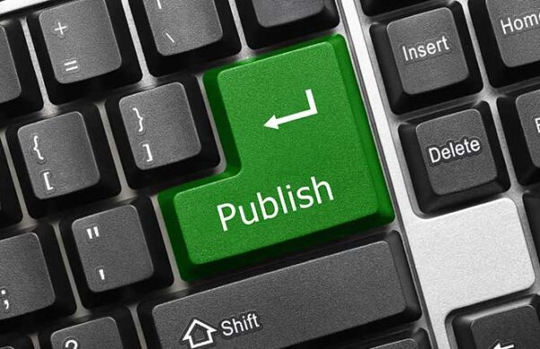 computer keyboard with green publish button in place of the enter key