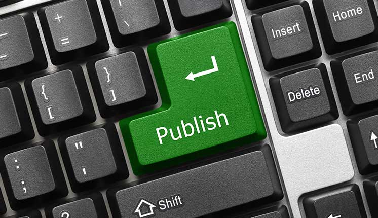 computer keyboard with green publish button in place of the enter key