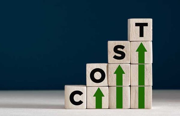 blocks with the letters C-O-S-T sitting on top of upward facing green arrows