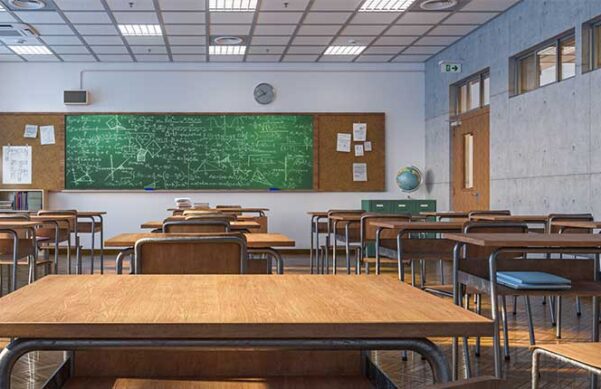 classroom with chalkboard and desks