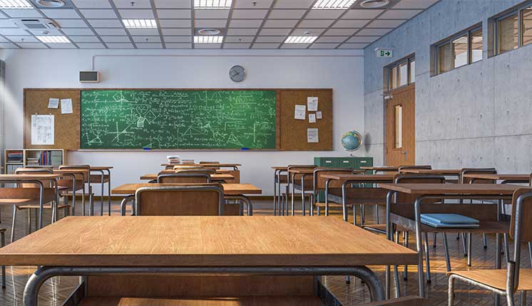 classroom with chalkboard and desks