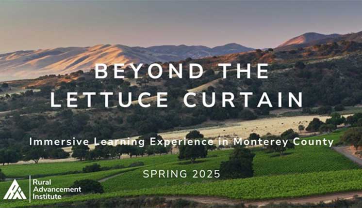 words on top of a backdrop of rolling hills behind a body of water and green field
