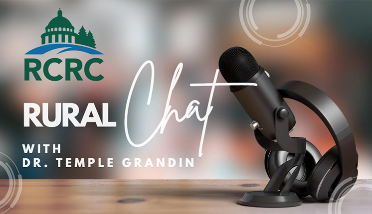 blurred background with microphone in the foreground along with the RCRC logo and words "Rural Chat with Dr. Temple Grandin"