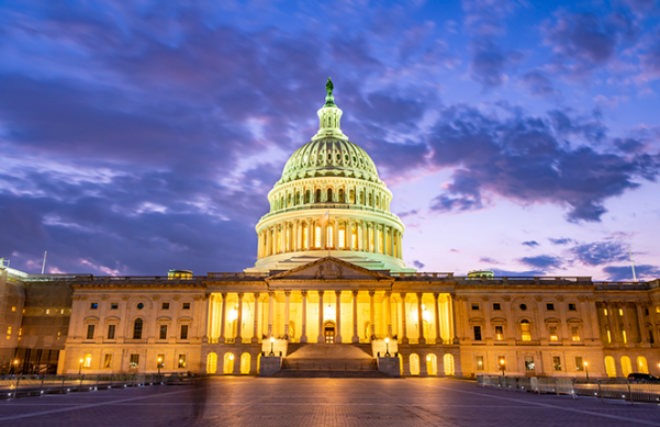 US capitol building lit up in the night sky.