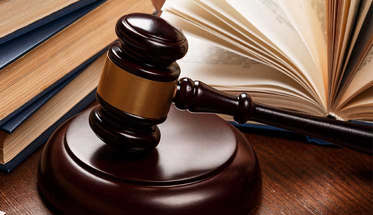 gavel in front of books on tabletop