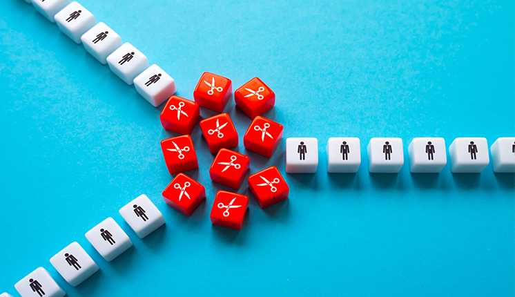 red cubes with white scissors on them, grouped between three lines of white cubes with human shapes on them, against blue background