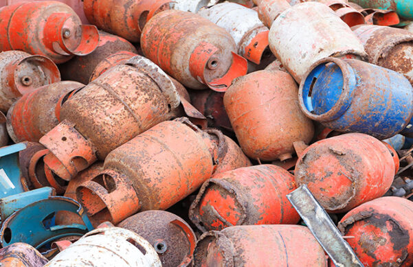 old propane tanks in a dirty pile